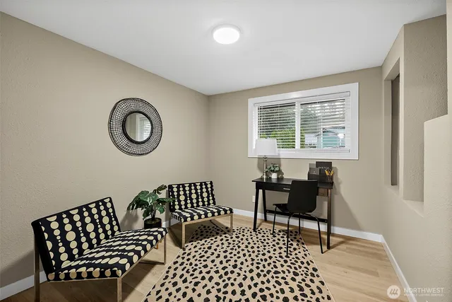 a bedroom with a chair and a window