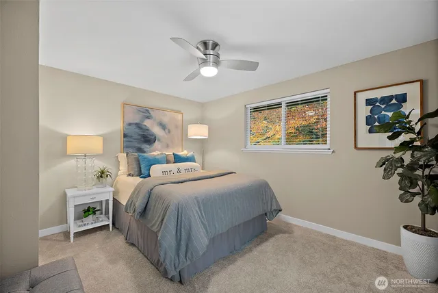 a bedroom with a bed and a potted plant
