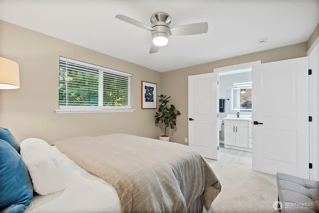a spacious bedroom with a large bed and a chandelier