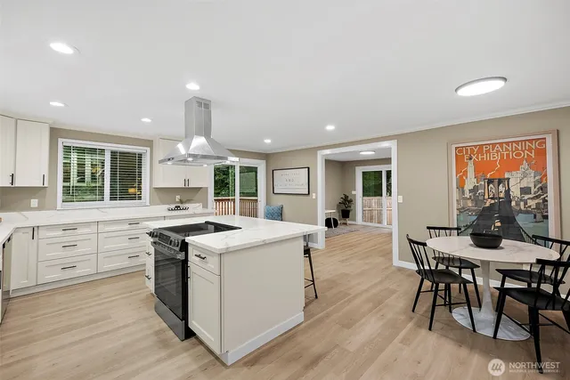 a kitchen with stove a sink and chairs