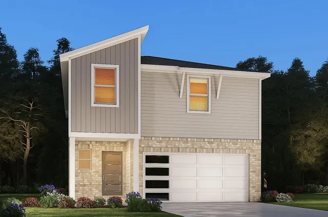 a front view of a house with plants