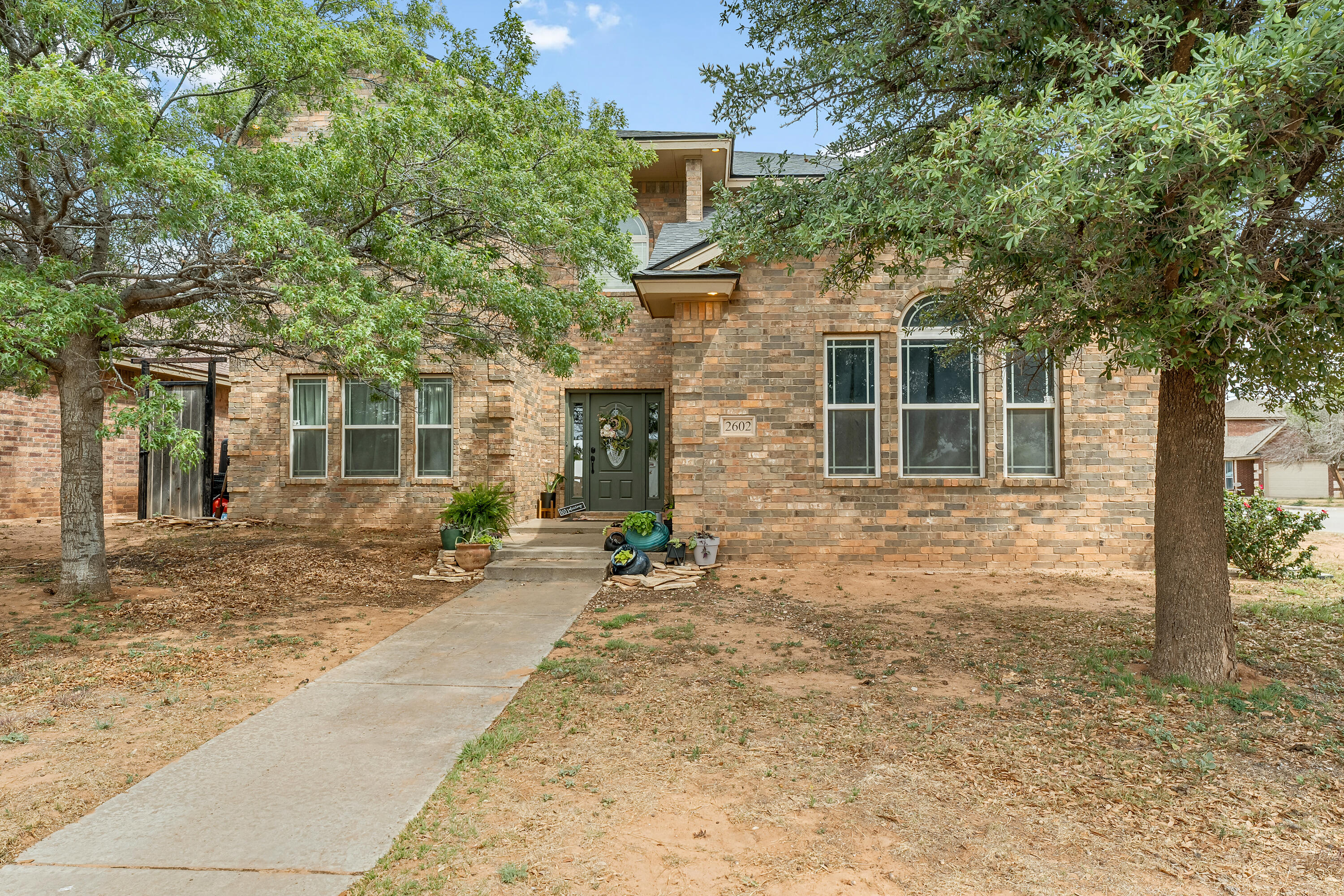 front view of a house with a tree