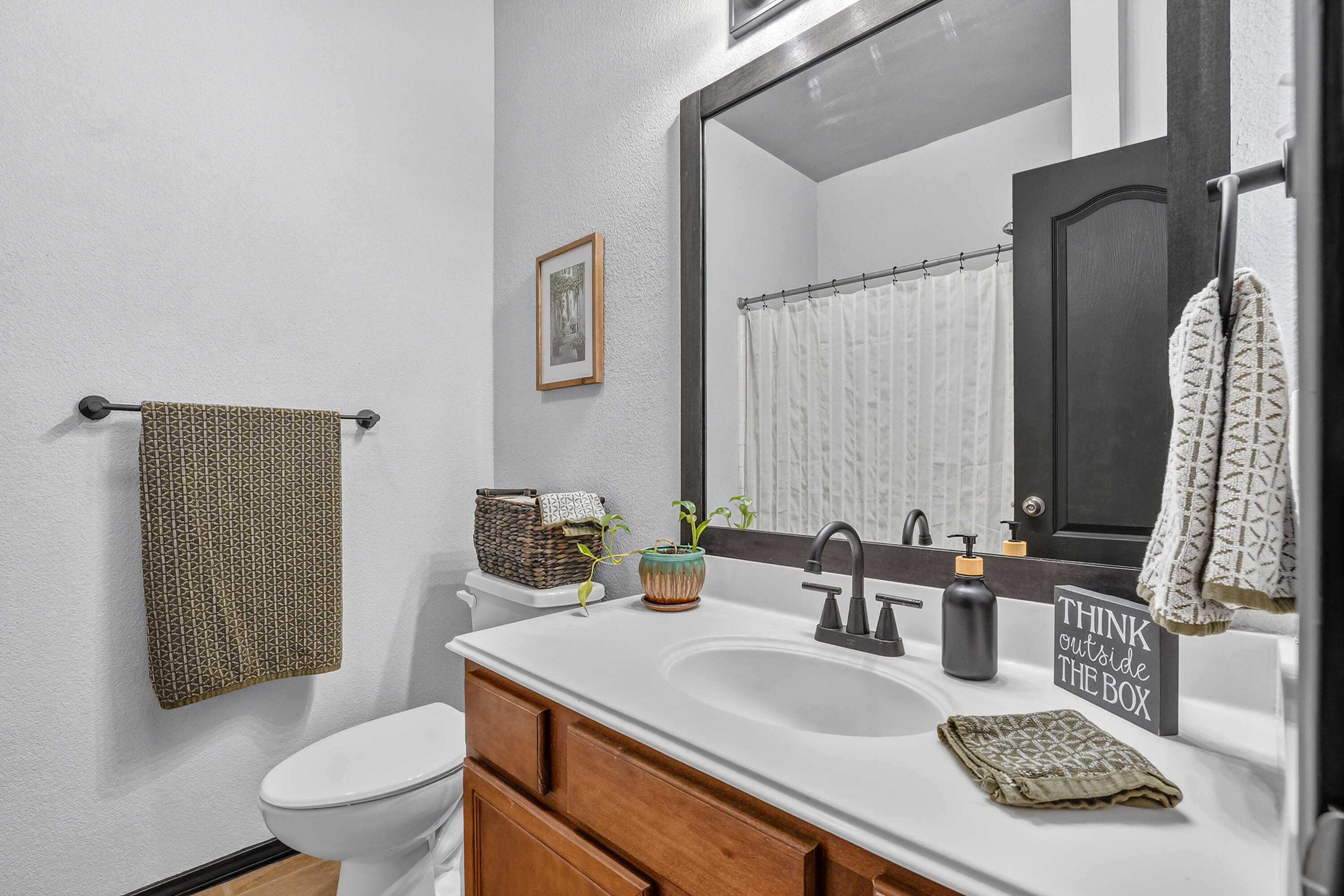 2602 112th Street Lubbock, TX 79423 - Photo 13 of 19 a bathroom with a granite countertop sink toilet and mirror