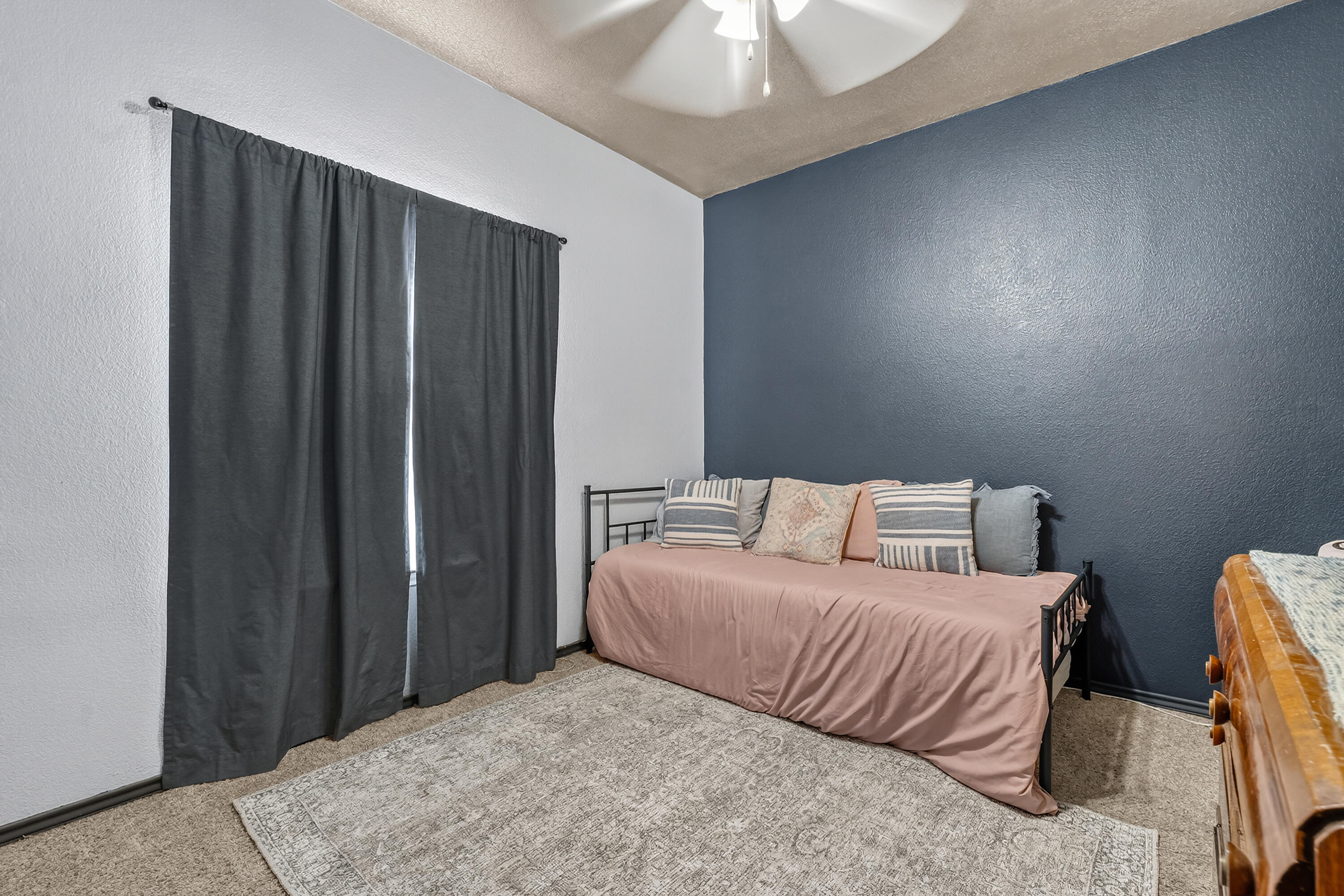 2602 112th Street Lubbock, TX 79423 - Photo 14 of 19 a bedroom with a bed and a chandelier