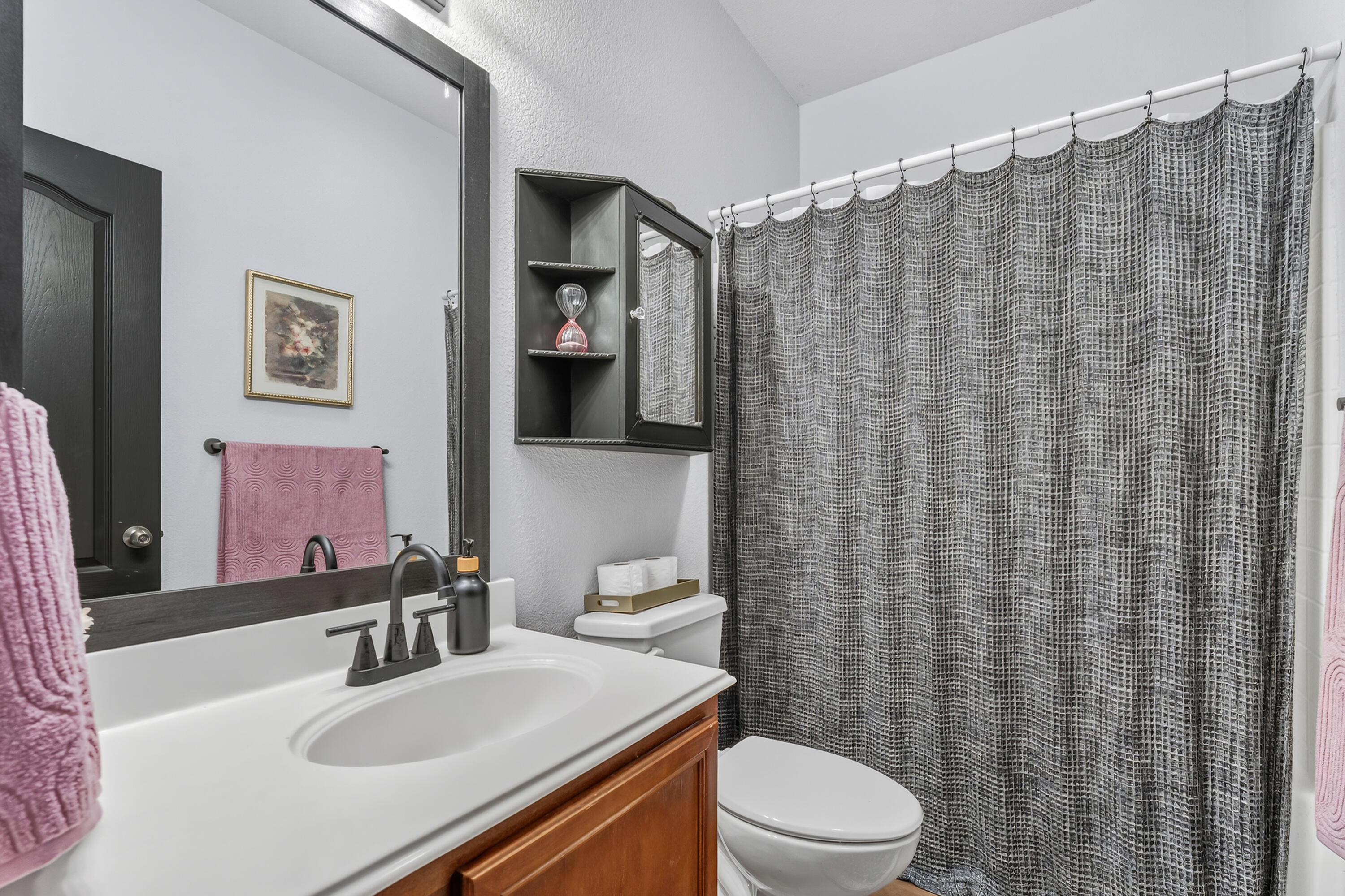 2602 112th Street Lubbock, TX 79423 - Photo 18 of 19 a bathroom with a sink a toilet and shower curtain