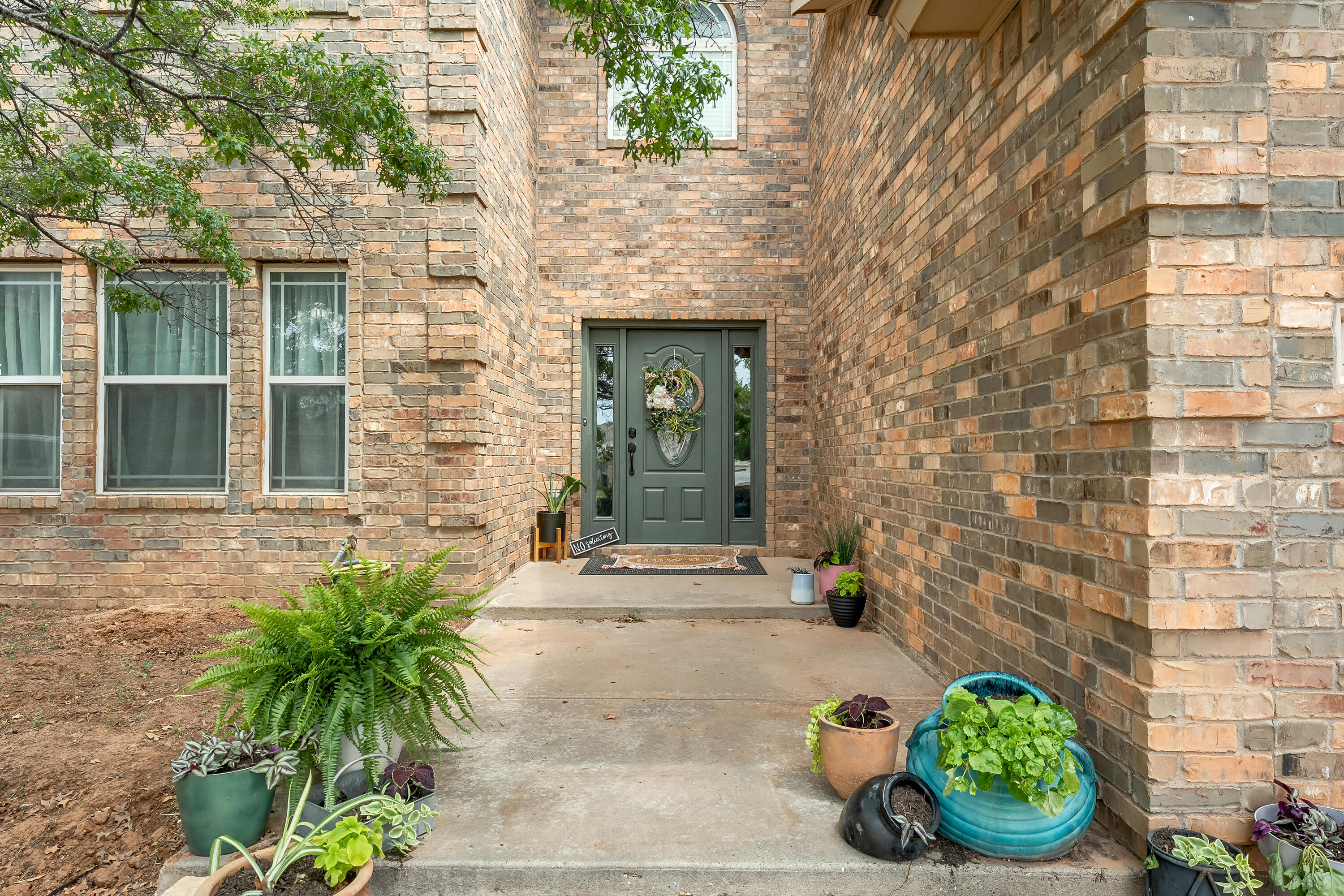 2602 112th Street Lubbock, TX 79423 - Photo 2 of 19 a front view of a house with potted plants