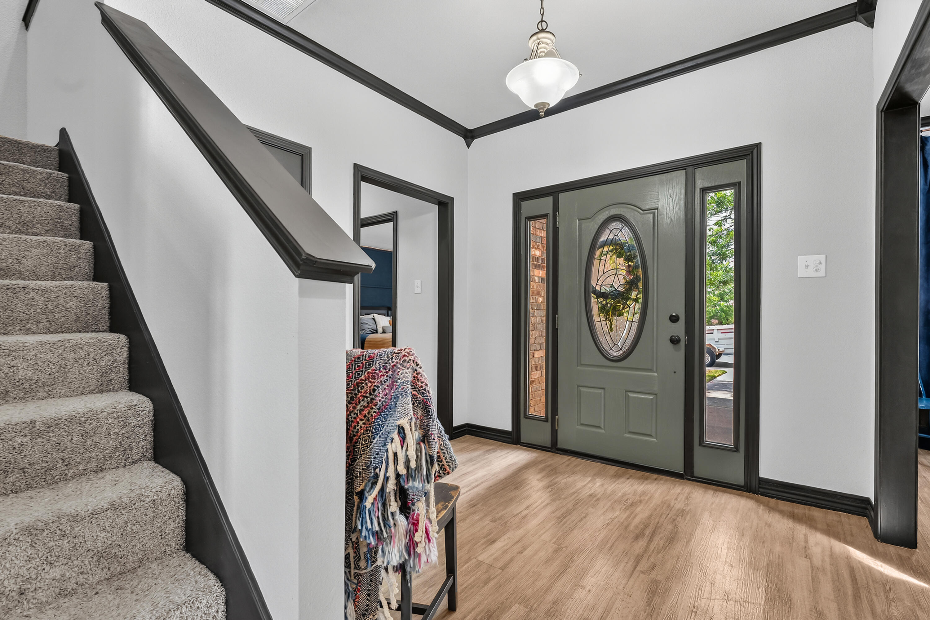 2602 112th Street Lubbock, TX 79423 - Photo 3 of 19 a view of a hallway with entryway wooden floor windows and a chandelier