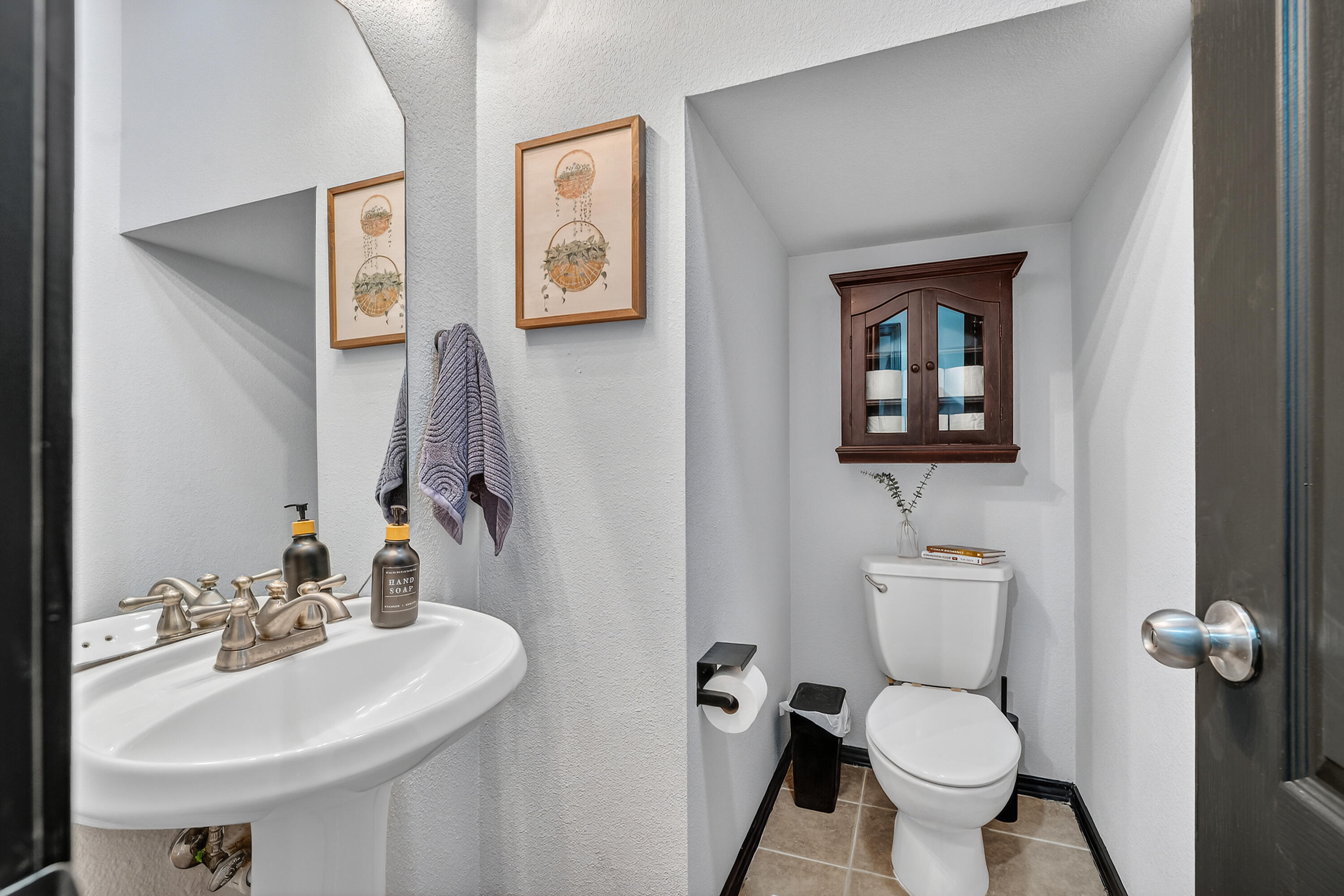 2602 112th Street Lubbock, TX 79423 - Photo 4 of 19 a bathroom with a toilet sink and mirror