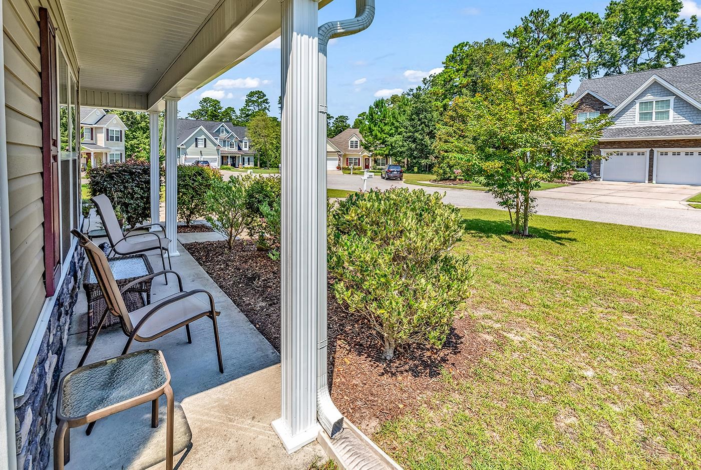 2009 Spring Valley Court Loris, SC 29569 - Photo 3 of 36 View of patio with a garage and a porch