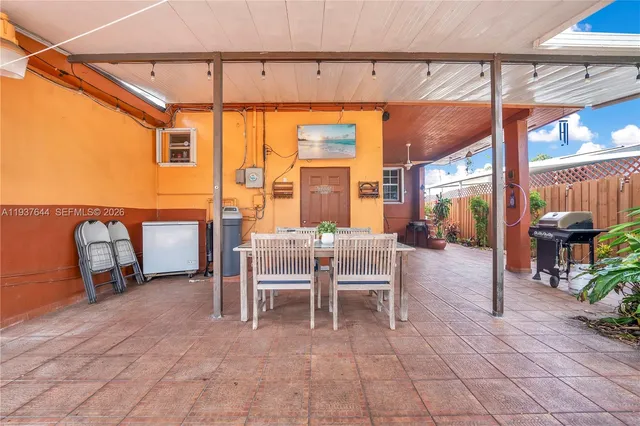 a view of a chairs and a fire pit in the patio