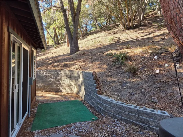 a view of a yard with wooden fence