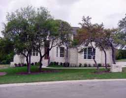 6021 Cervinus Run Austin, TX 78735 - Photo 1 of 1 front view of house with a yard