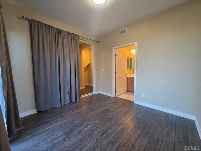 a view of a room with wooden floor and a window