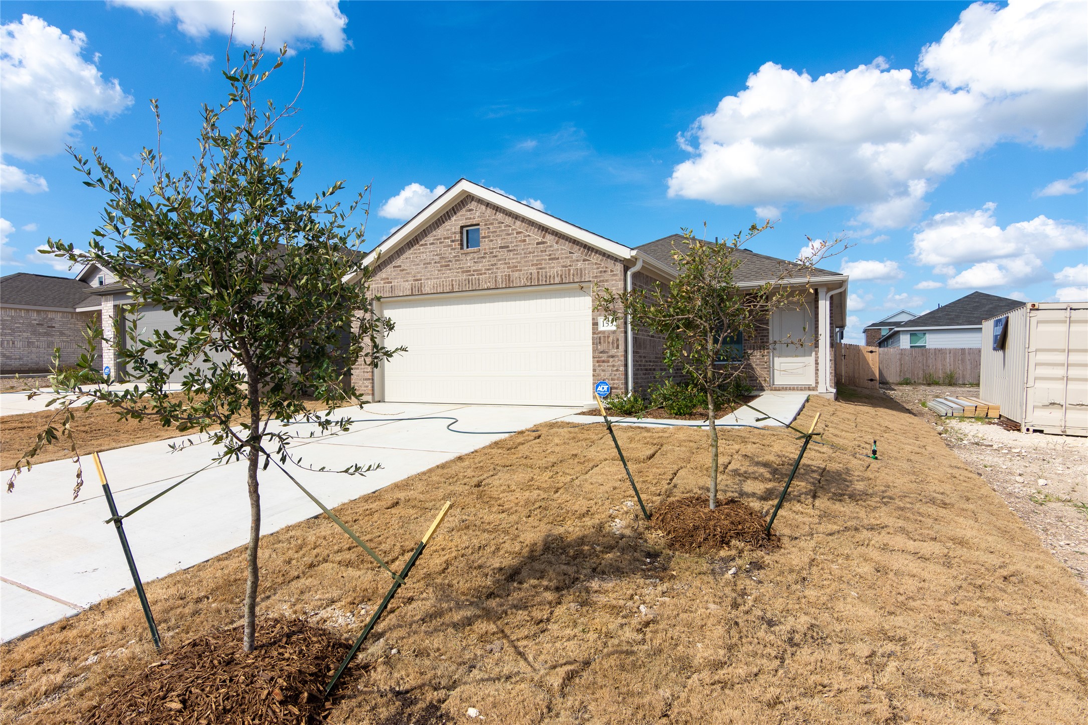 153 Star Packer Lane Jarrell, TX 76537 - Photo 3 of 30 A newly built residence with a brick facade and an attached garage offers inviting curb appeal.