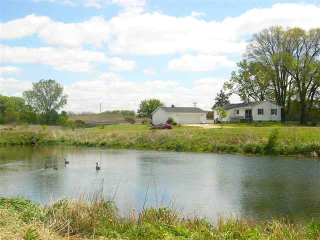 14363 Ideal Road Thomson, IL 61285 - Photo 1 of 12 a view of a lake with houses in the back