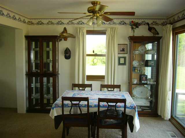 14363 Ideal Road Thomson, IL 61285 - Photo 4 of 12 a dining room with a wooden table and chairs