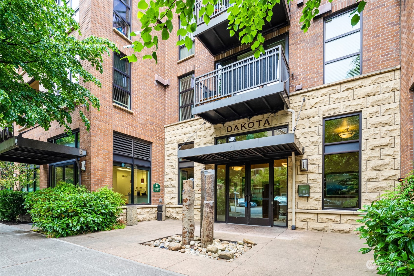 4116 California Avenue Southwest, Unit 313 Seattle, WA 98116 - Photo 1 of 18 a front view of a brick building with large windows