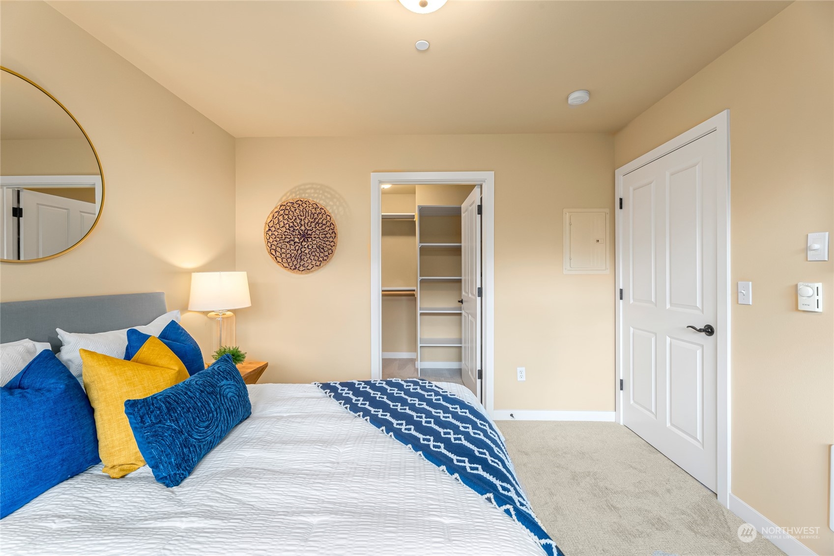4116 California Avenue Southwest, Unit 313 Seattle, WA 98116 - Photo 11 of 18 a bedroom with a bed and a chandelier