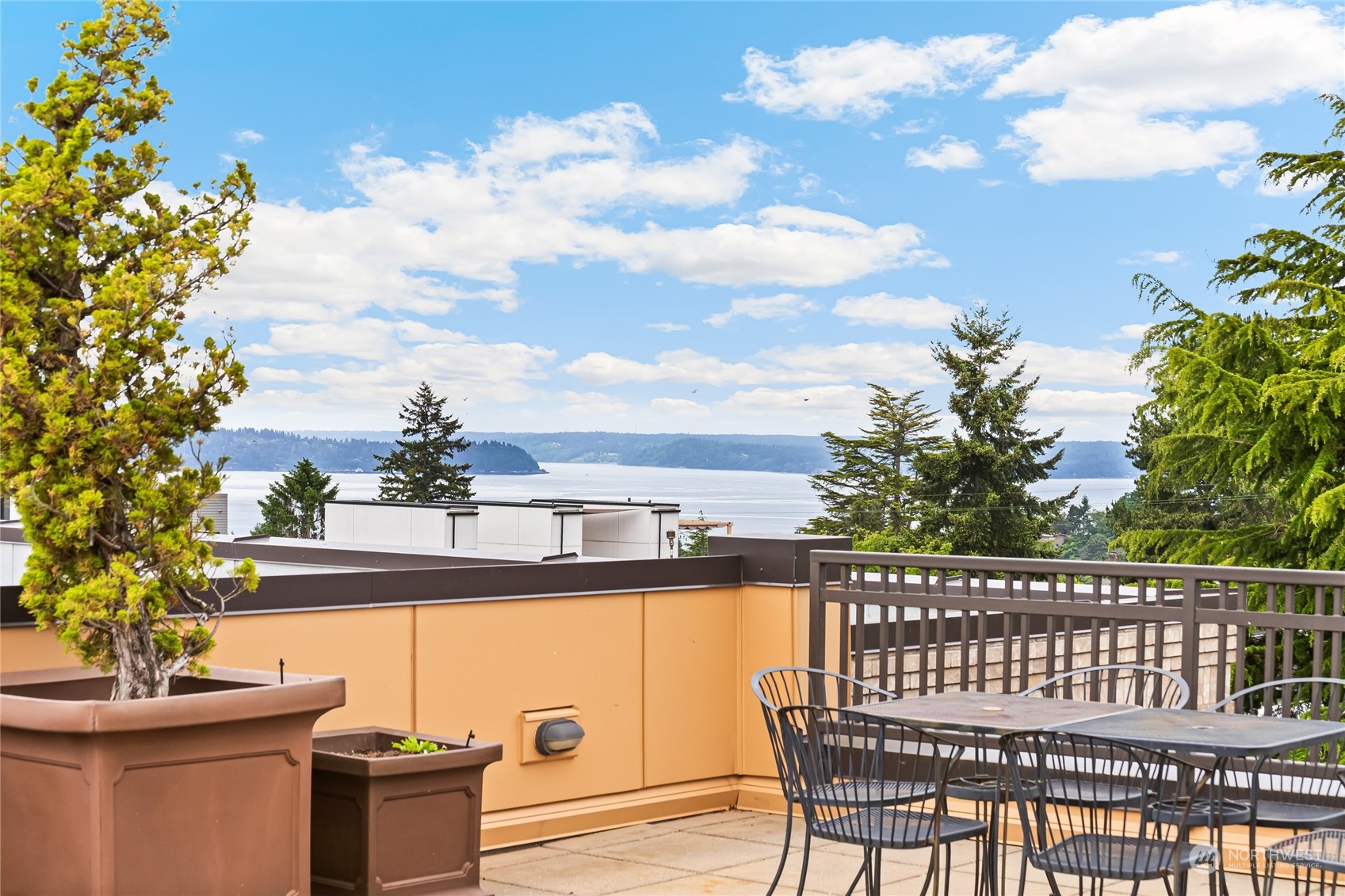 4116 California Avenue Southwest, Unit 313 Seattle, WA 98116 - Photo 16 of 18 a balcony with table and chairs