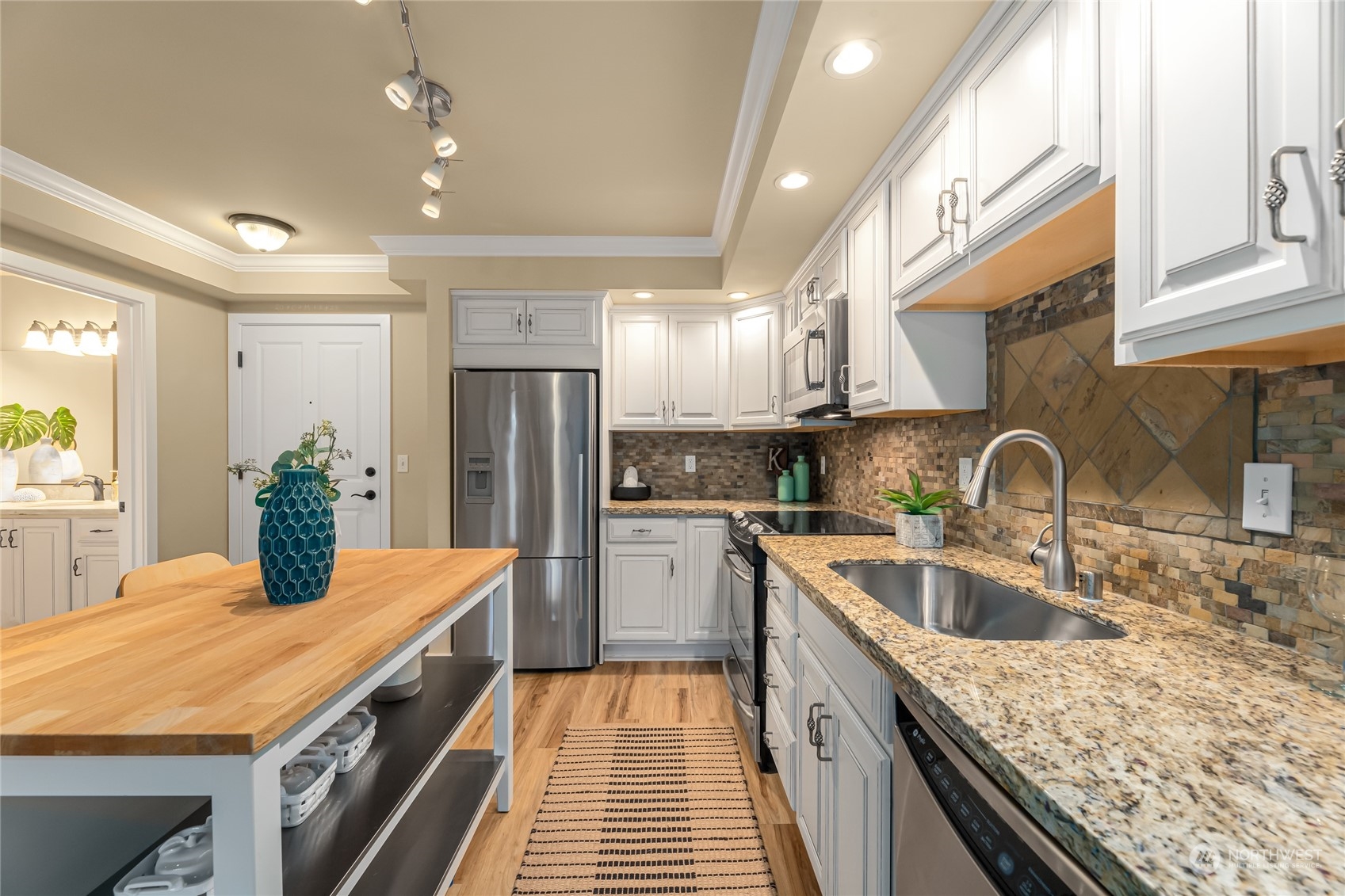 4116 California Avenue Southwest, Unit 313 Seattle, WA 98116 - Photo 4 of 18 a kitchen with a sink stove and refrigerator