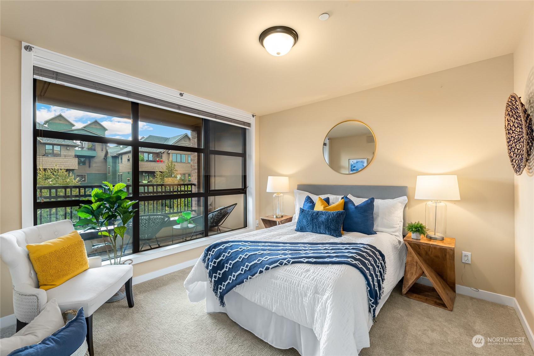 4116 California Avenue Southwest, Unit 313 Seattle, WA 98116 - Photo 9 of 18 a bedroom with a bed and glass window