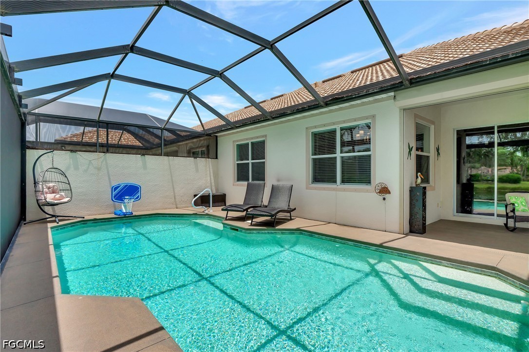 11230 Suffield Street Fort Myers, FL 33913 - Photo 23 of 42 a view of a backyard with table and chairs under an umbrella