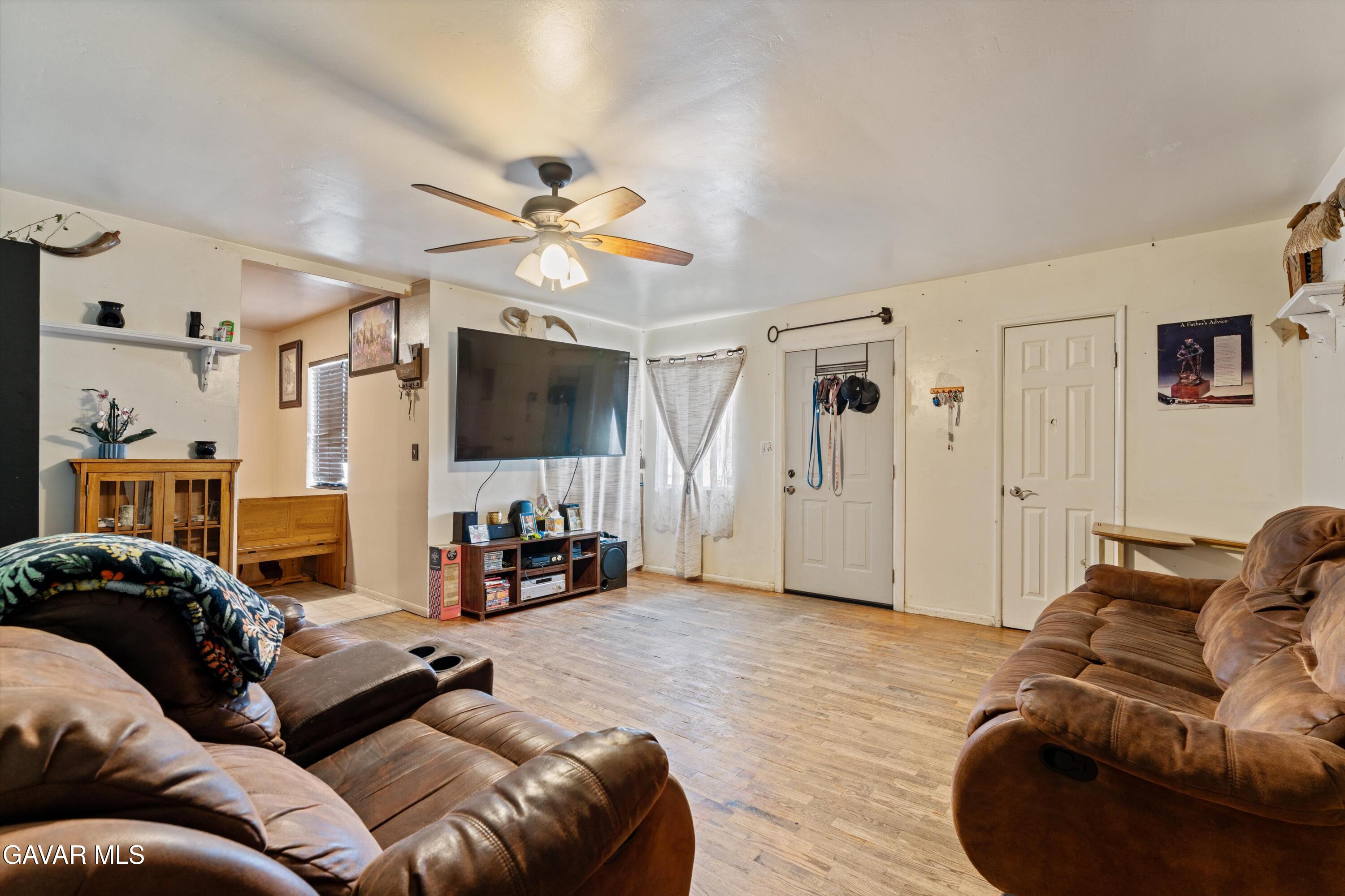 817 Oakwood Street Tehachapi, CA 93561 - Photo 5 of 12 a living room with furniture and a flat screen tv