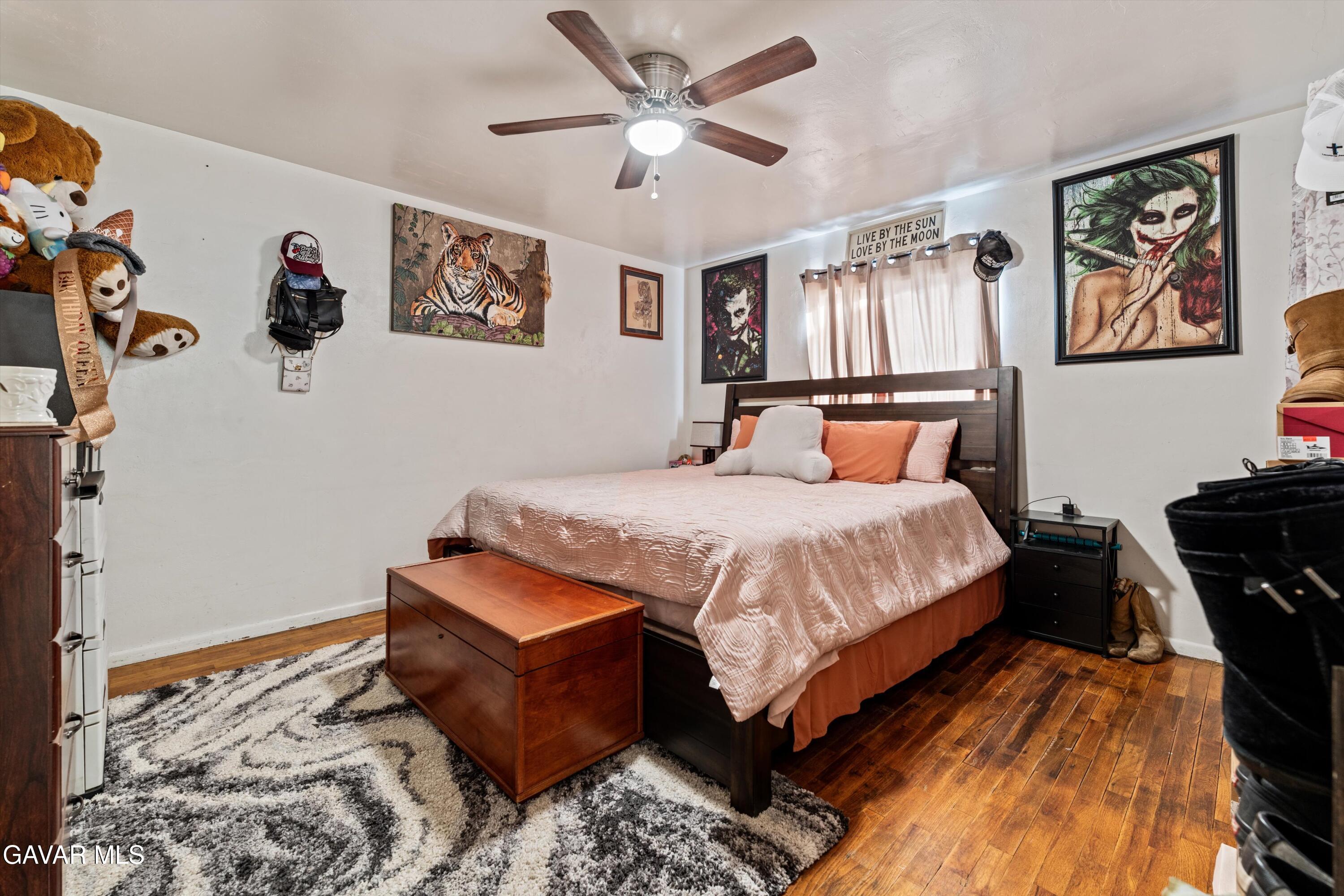 817 Oakwood Street Tehachapi, CA 93561 - Photo 9 of 12 a bedroom with a bed and wooden floor