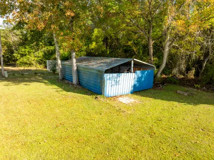 a view of a house with a yard and tree s