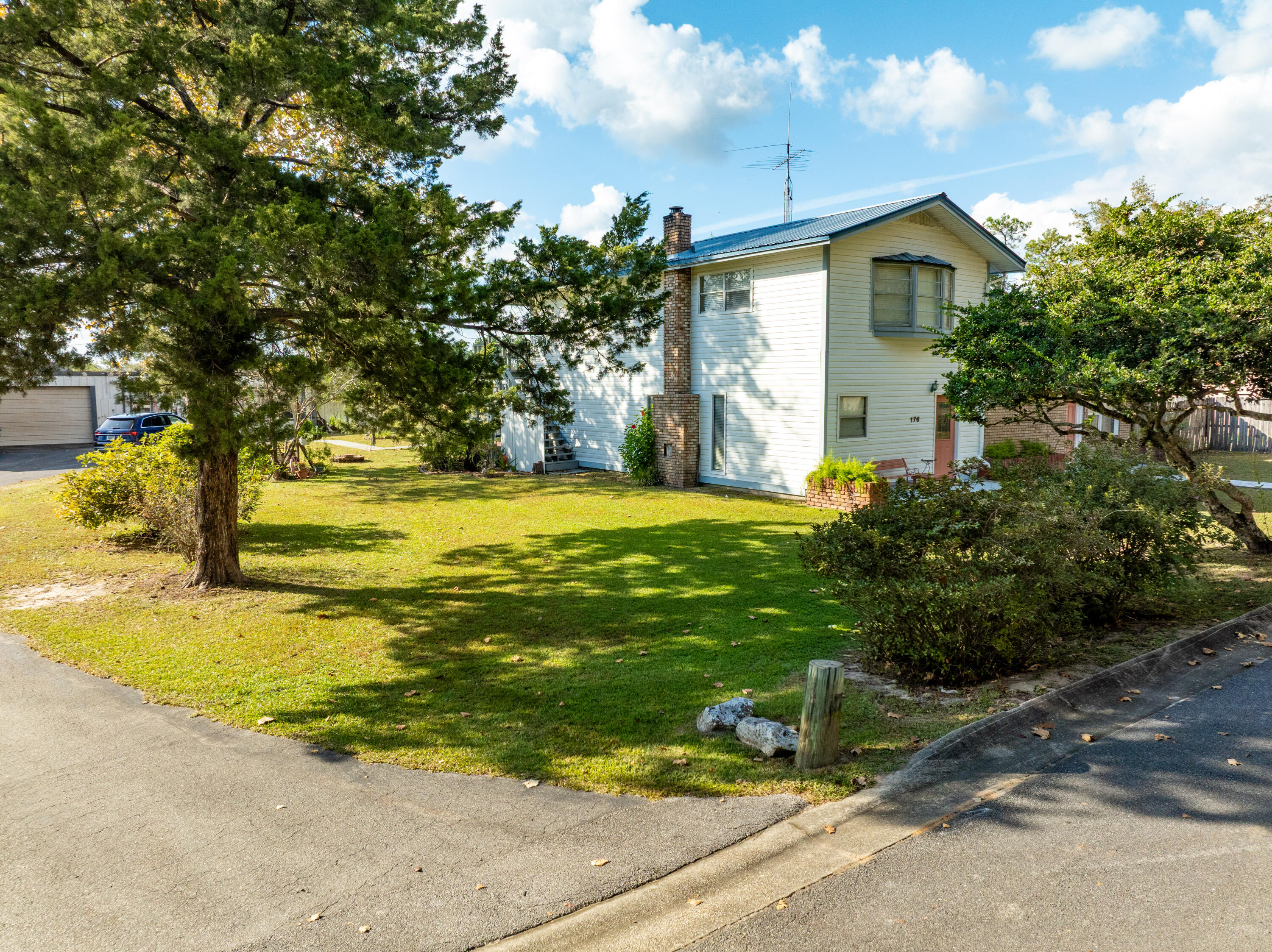 176 Bourbon Street Freeport, FL 32439 - Photo 10 of 15 a view of a house with a yard and tree s