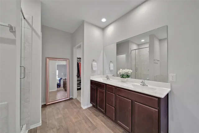 a bathroom with a double vanity sink and mirror
