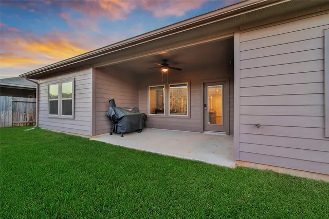 a view of a backyard with potted plants and a table