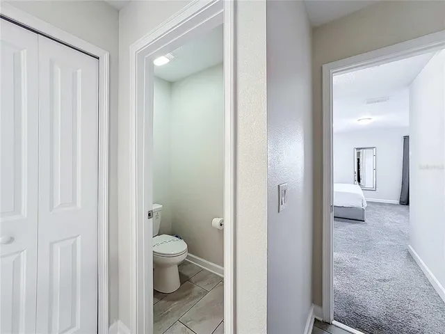 a bathroom with a shower a toilet and a sink