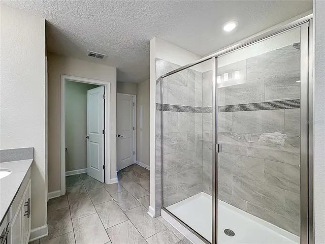 a large bed sitting in a room next to a window