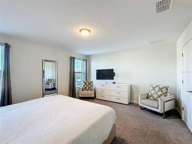 a living room with furniture and a mirror