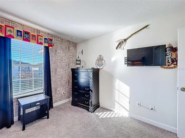 a view of a dining room and livingroom with furniture wooden floor a chandelier