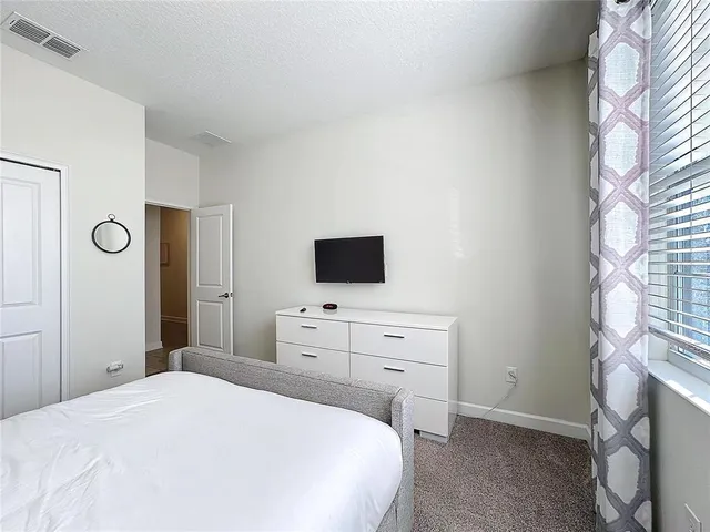 a room with gym equipment and a flat screen tv