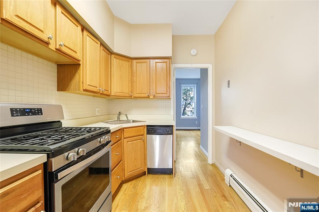 523 Adams Street, Unit 3 Hoboken, NJ 07030 - Photo 10 of 19 a kitchen with stainless steel appliances a stove a sink and cabinets