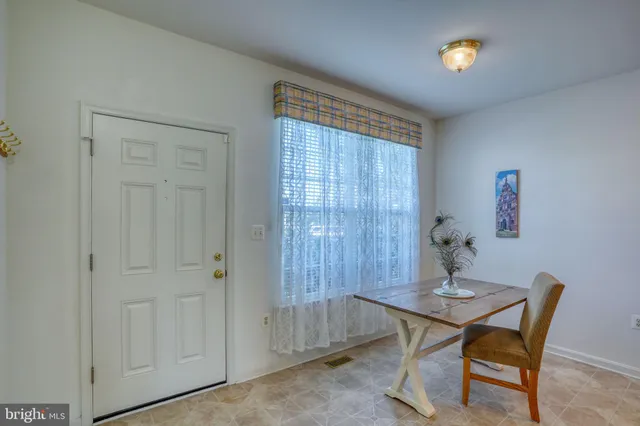 a view of a dining room with furniture and chandelier