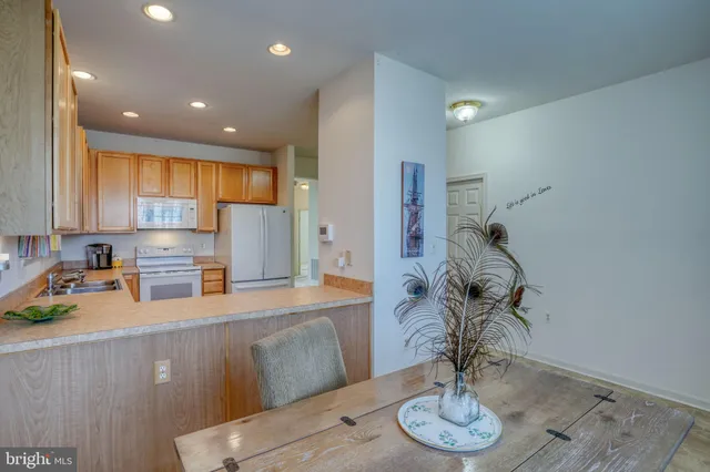 a kitchen with stainless steel appliances granite countertop a sink a refrigerator and a granite counter tops