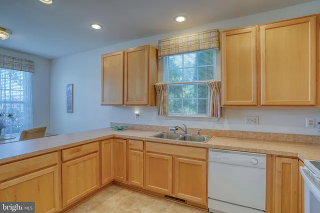 a kitchen with a sink cabinets and window