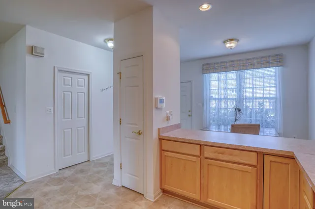 a hallway with sink and mirror