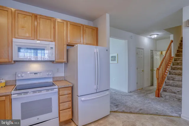 a kitchen with a refrigerator stove and cabinets