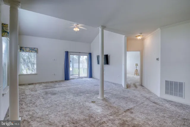 a view of a big room with windows and closet