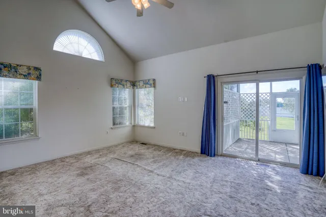 an empty room with windows and outdoor view