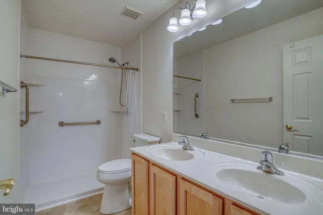 a bathroom with a sink toilet a mirror and shower