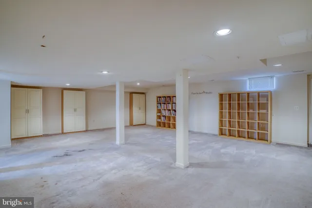 an empty room with closet and natural light