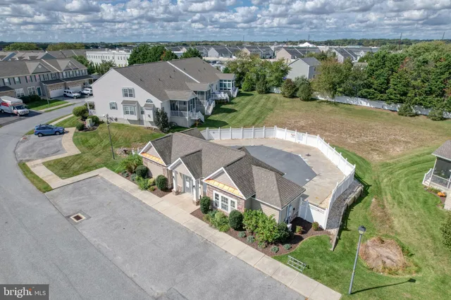 an aerial view of a house with garden space and street view