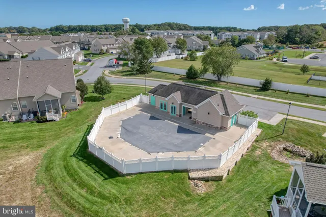 an aerial view of a house with a garden and swimming pool
