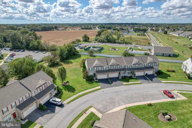 an aerial view of a house with a garden and lake view